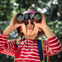 little-girl-using-binoculars-forest